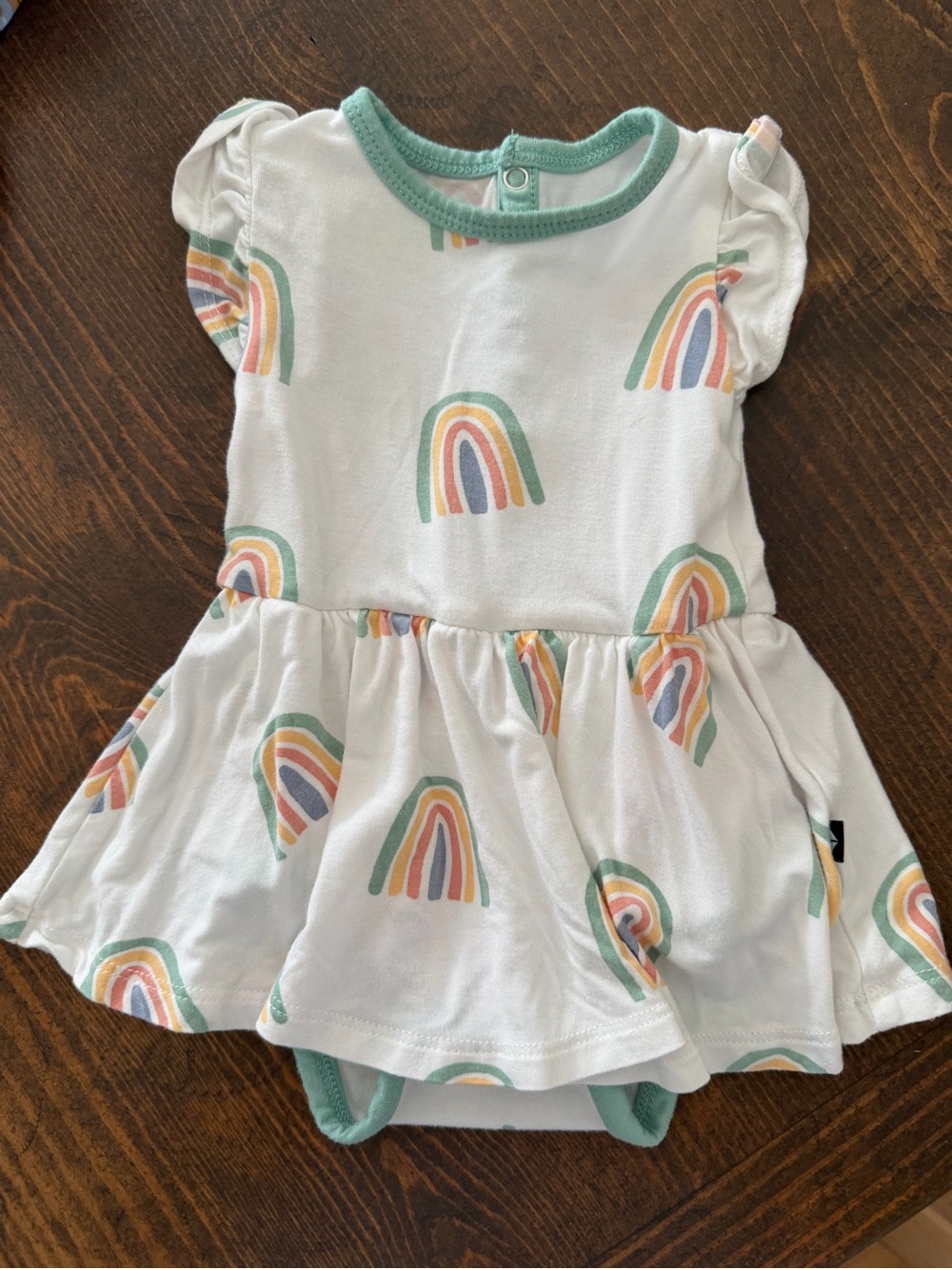 Kyte BABY White Dress Bodysuit with Pastel Rainbows and Green Trim